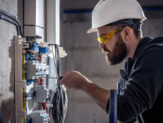 A maintenance worker fixing a MCB distribution board